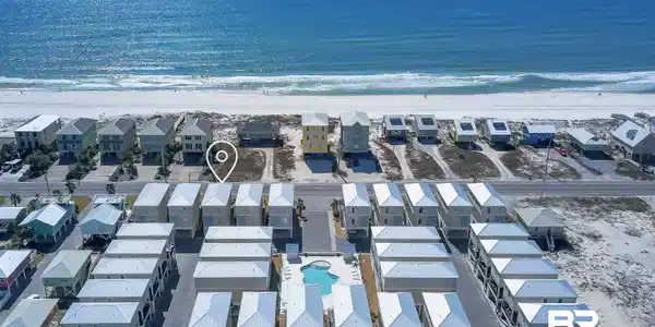 Image 2: Aerial perspective showcasing a collection of properties with proximity to the Gulf of Mexico
