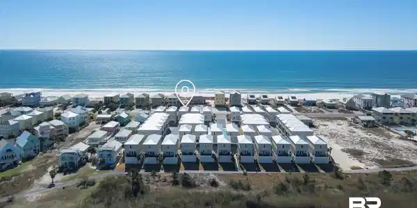 Image 3: Aerial perspective showcasing a coastal community with multiple properties