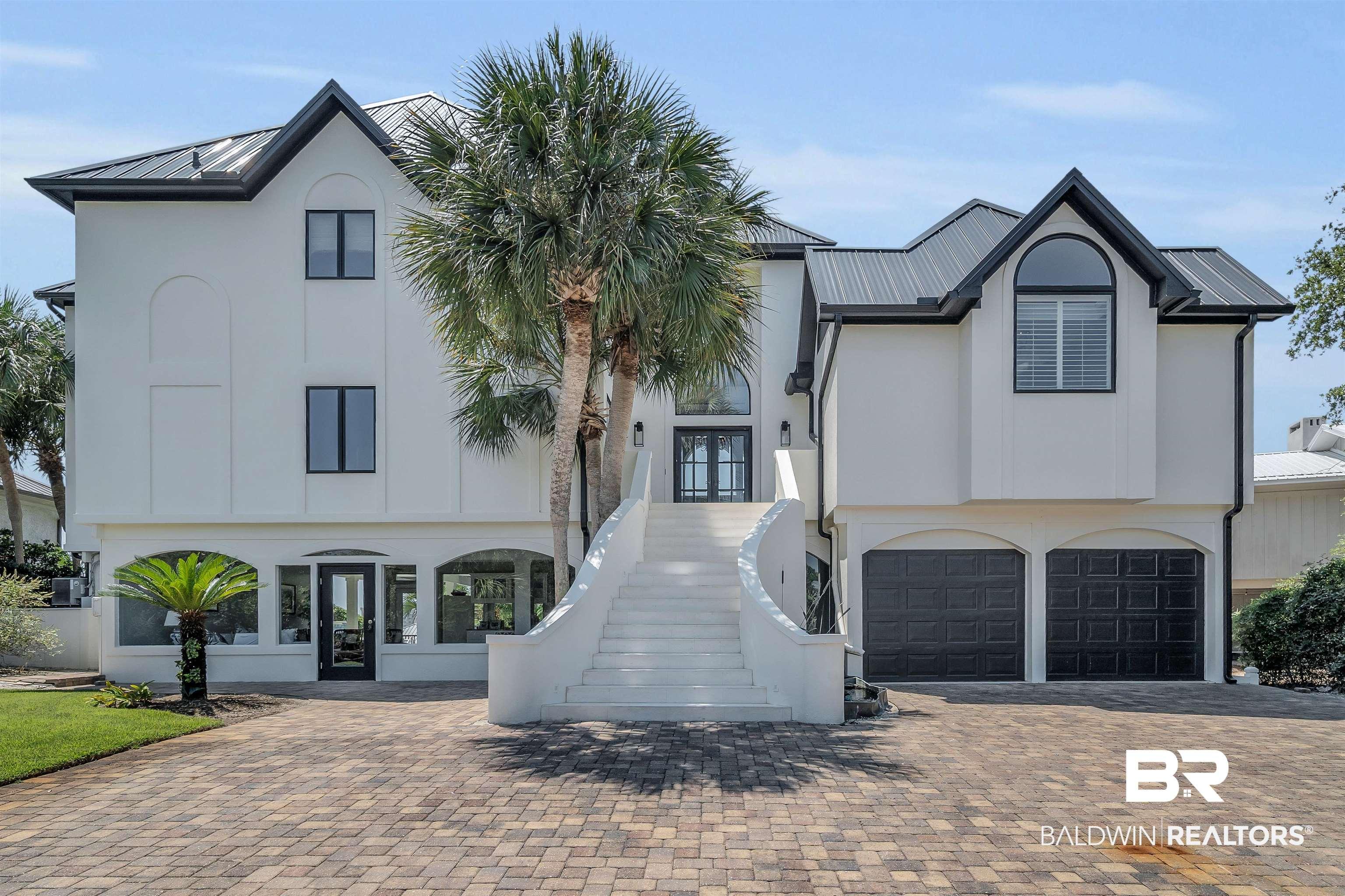 Image 3: View of front of property with french doors and a garage