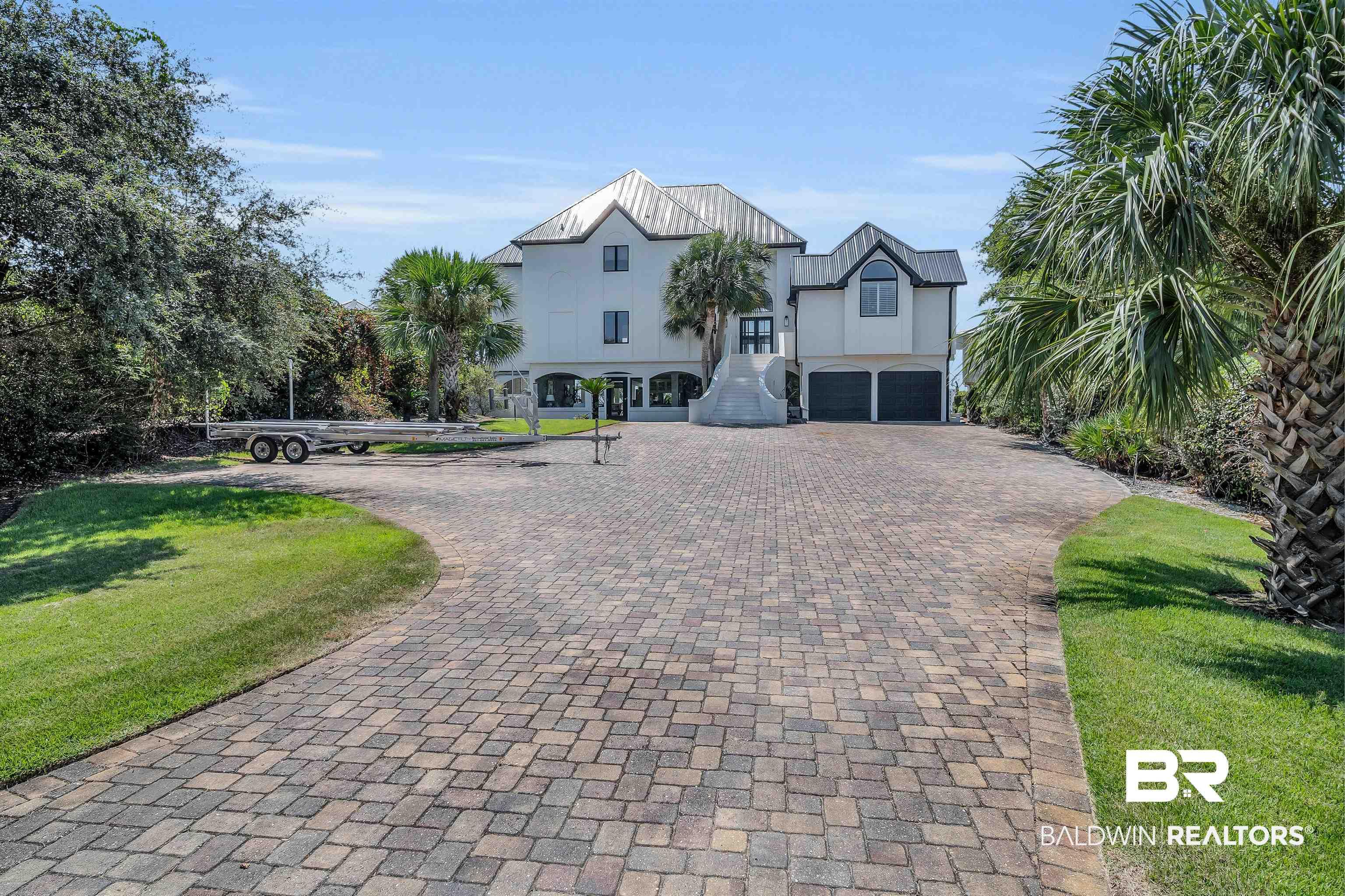 Image 4: View of front of property with a garage and a front yard