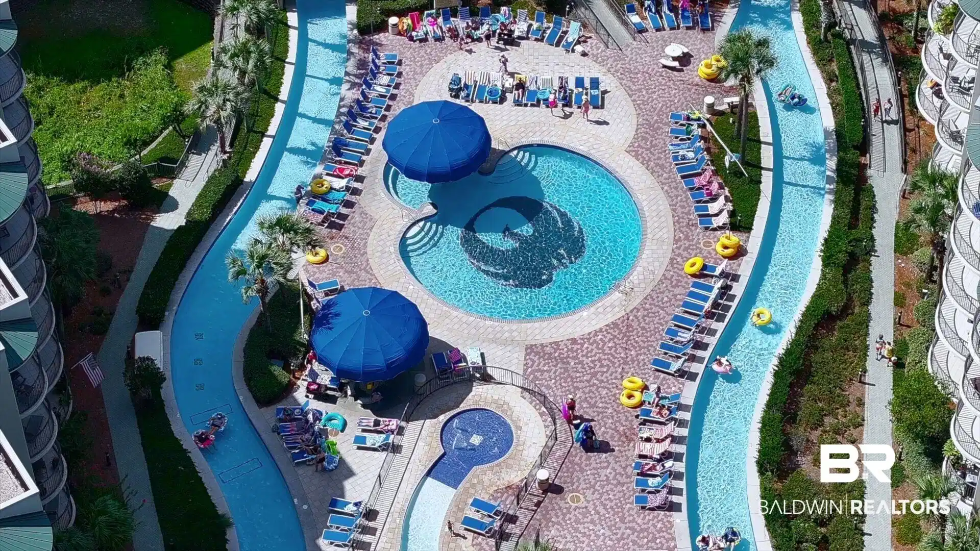 Image 1: Drone / aerial view of a pool area and a community park