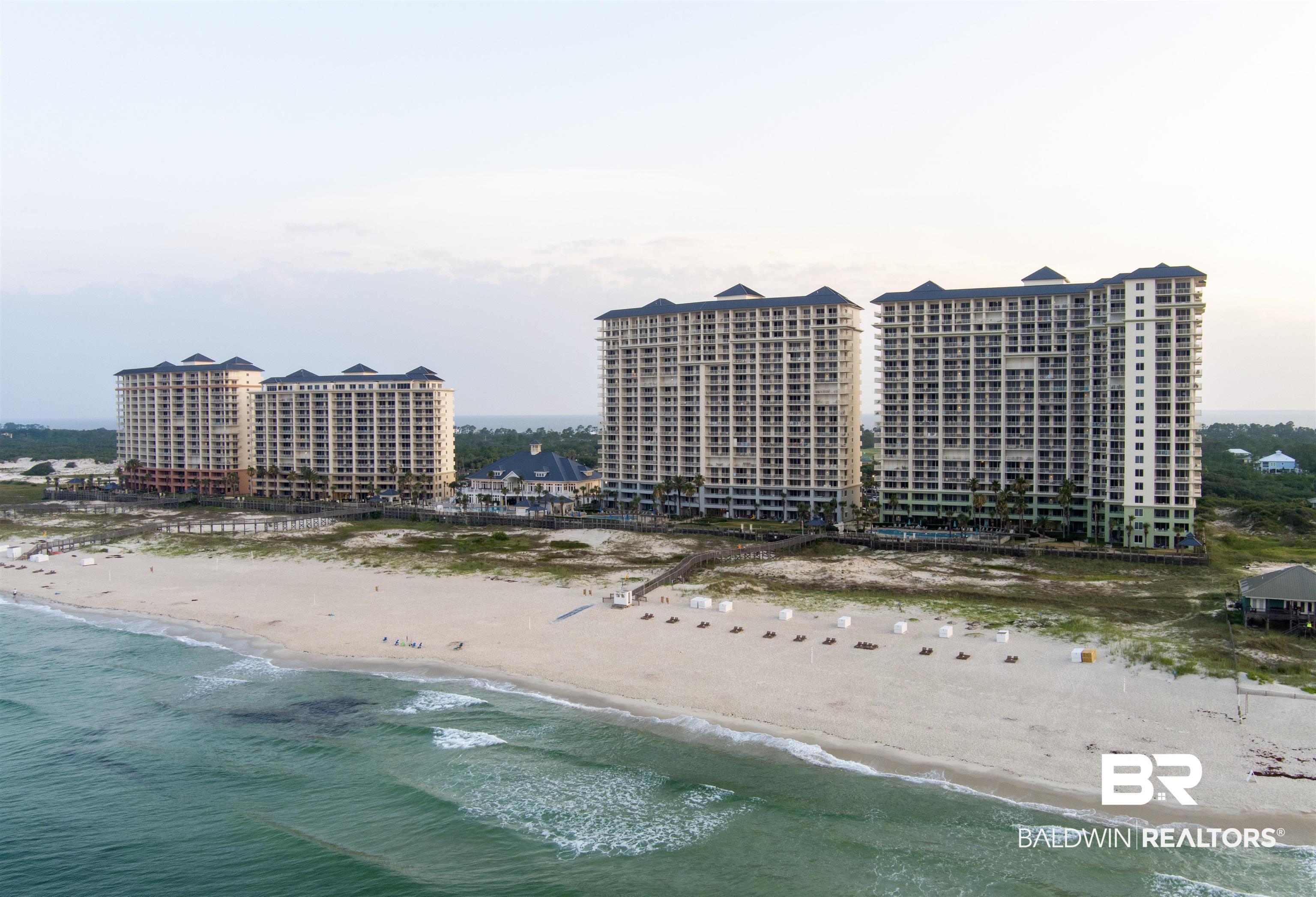 Image 2: Beachfront condominium complex featuring multiple high-rise buildings situated directly on a sandy shore