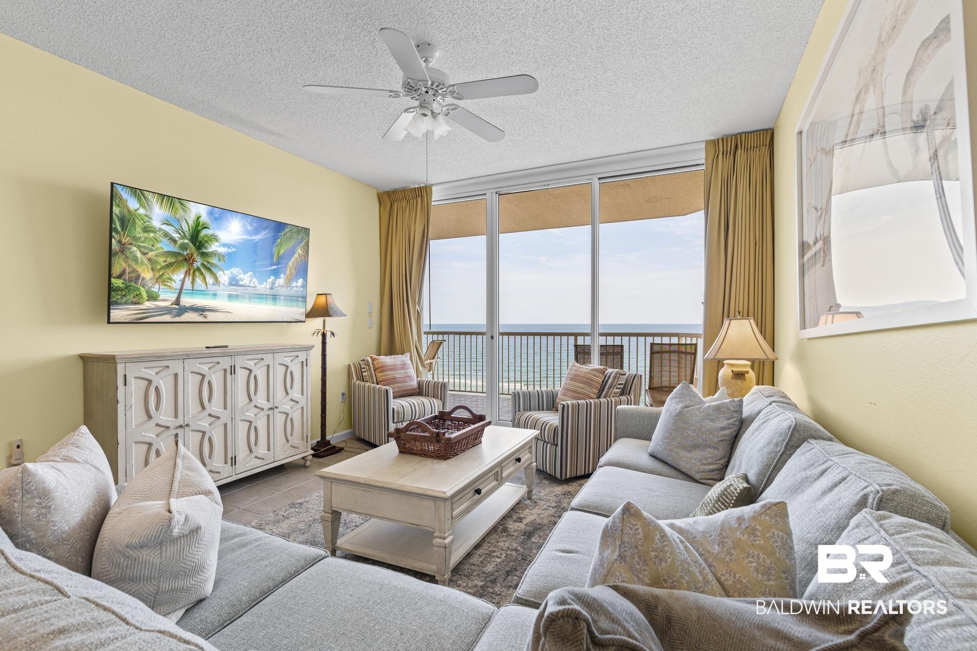 Image 3: Living area featuring a textured ceiling, a ceiling fan, and light-toned walls