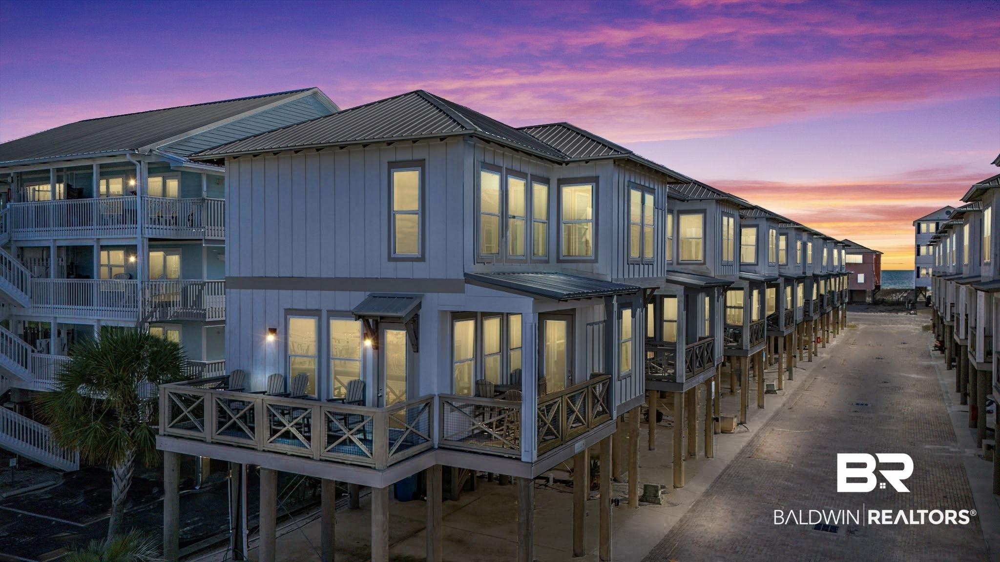 Image 3: Front of property at dusk with a metal roof and board and batten siding