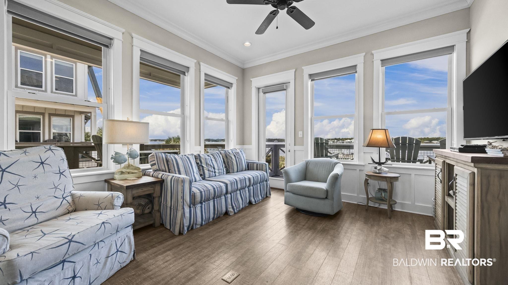 Image 4: Living room with ornamental molding, hardwood / wood-style floors, ceiling fan, and recessed lighting