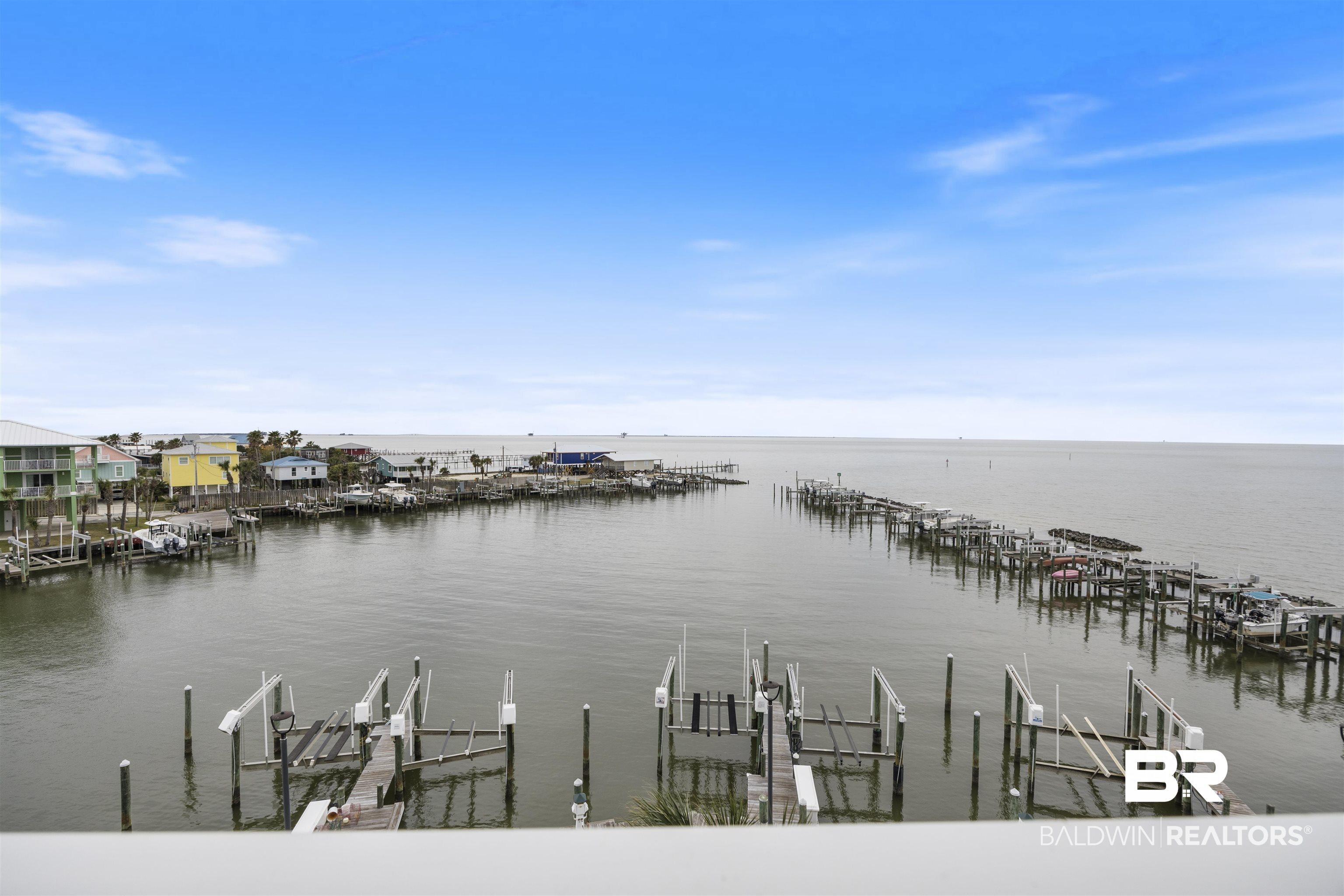 Image 3: Water view with boat lift, a dock, and numerous boat docks