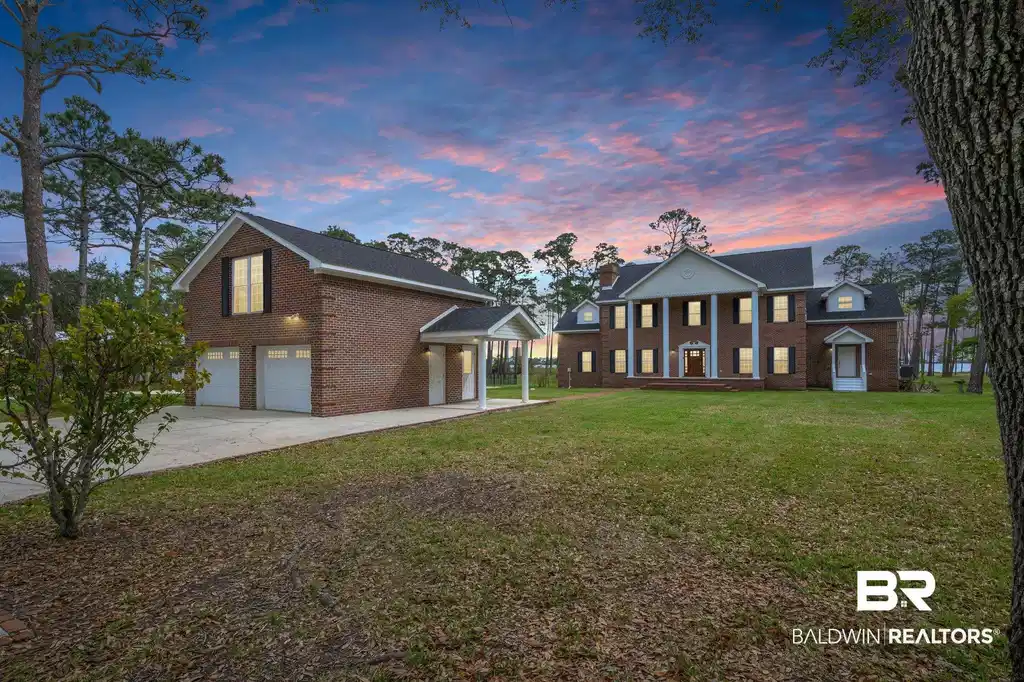 Image 1: Neoclassical home with a garage and a yard