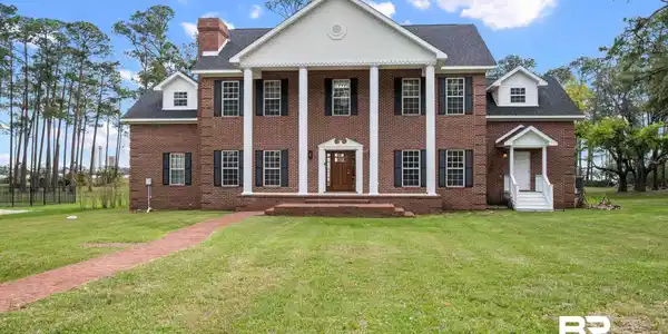 Image 3: Greek revival inspired property featuring a front lawn