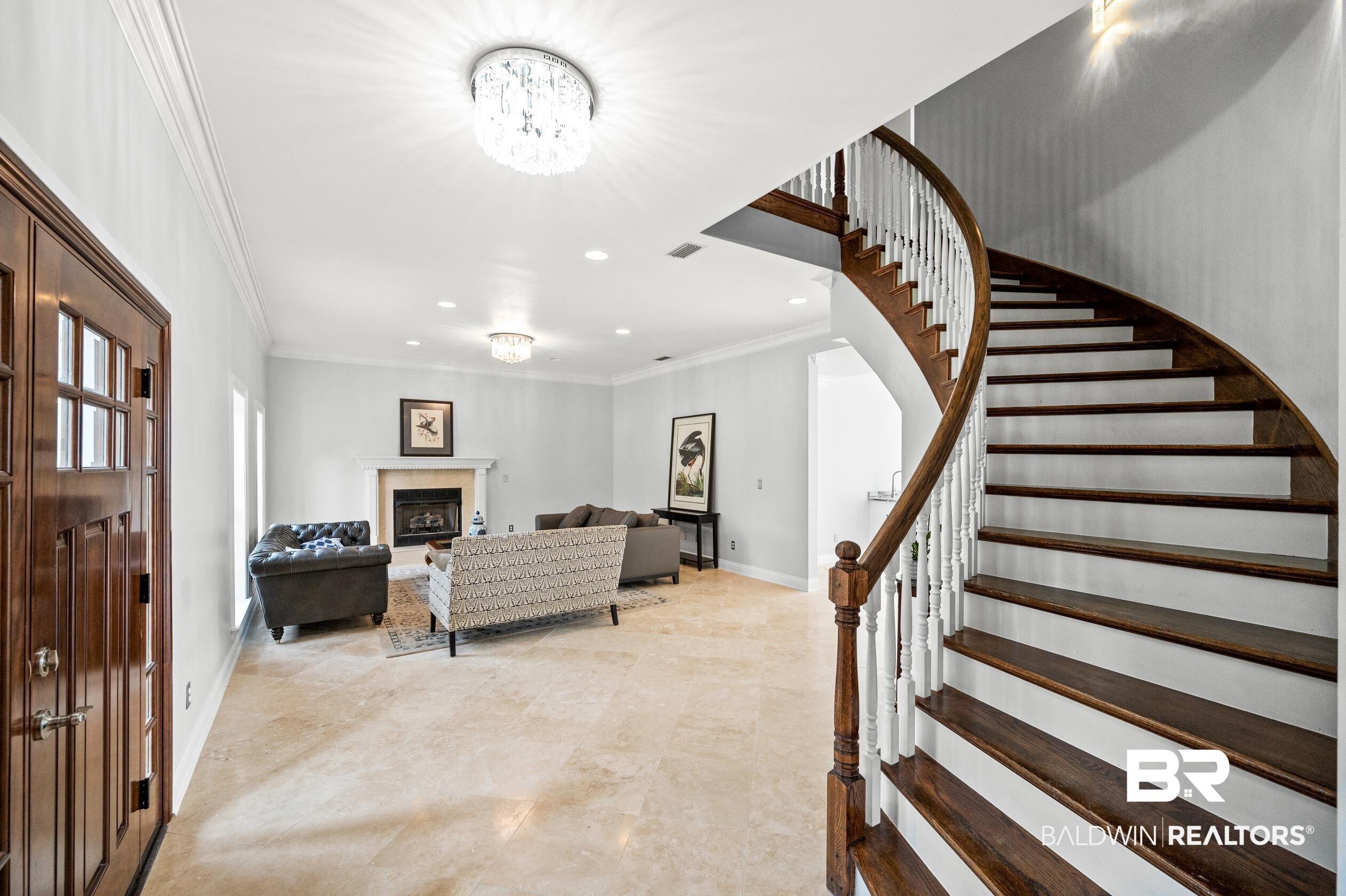 Image 4: Foyer entrance featuring light tile patterned floors and ornamental molding
