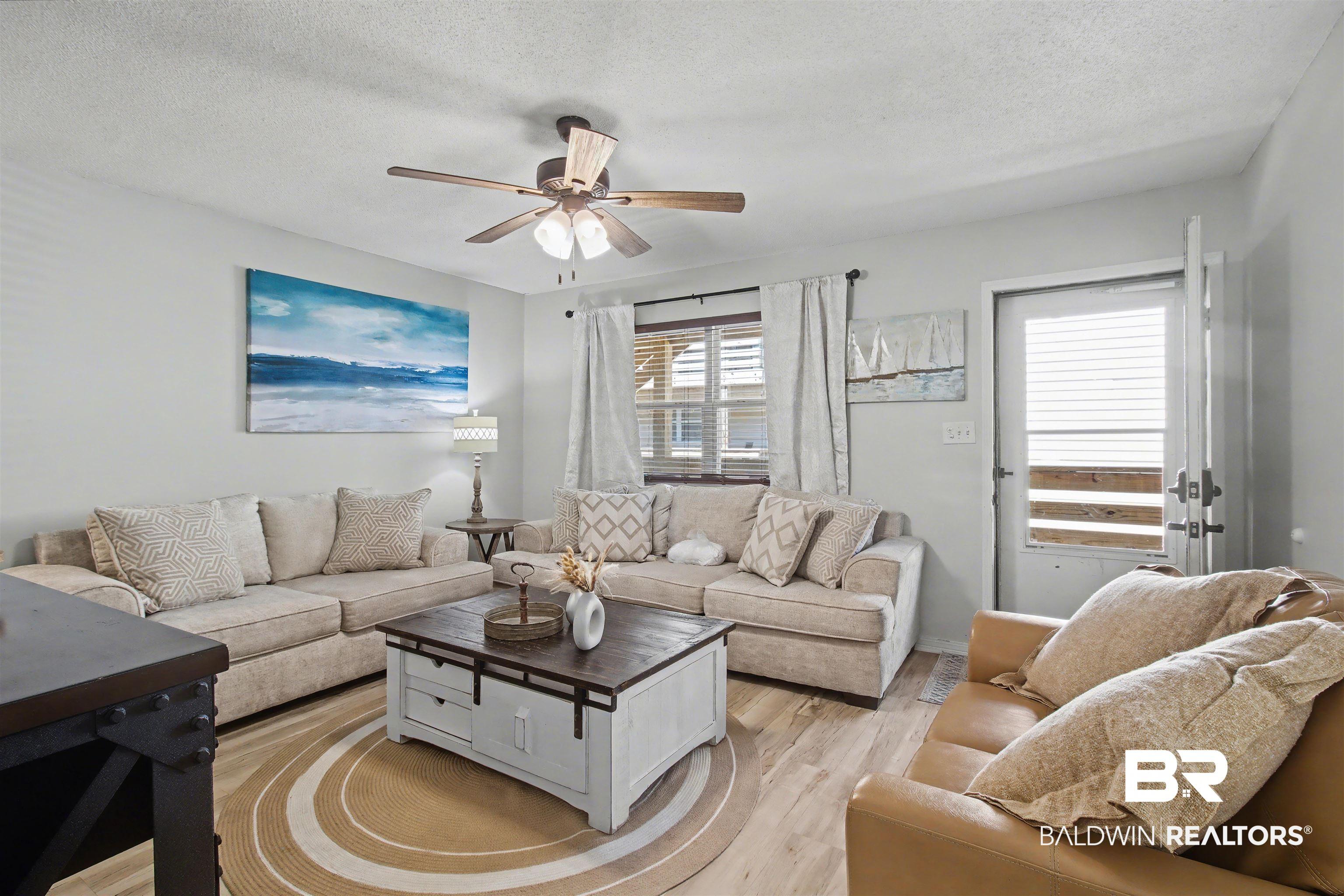 Image 2: Numerous Updates including vinyl flooring throughout, Painted Bathroom & Kitchen Cabinets with new hardware, updated Countertops- Quartz in the Kitchen and Granite in both Bathrooms. And more!