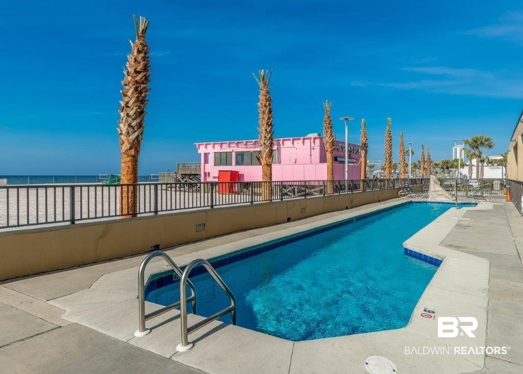 Image 3: Community pool with a patio area