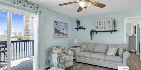 Image 2: Living room with wood finished floors, a textured ceiling, a city view, and ceiling fan