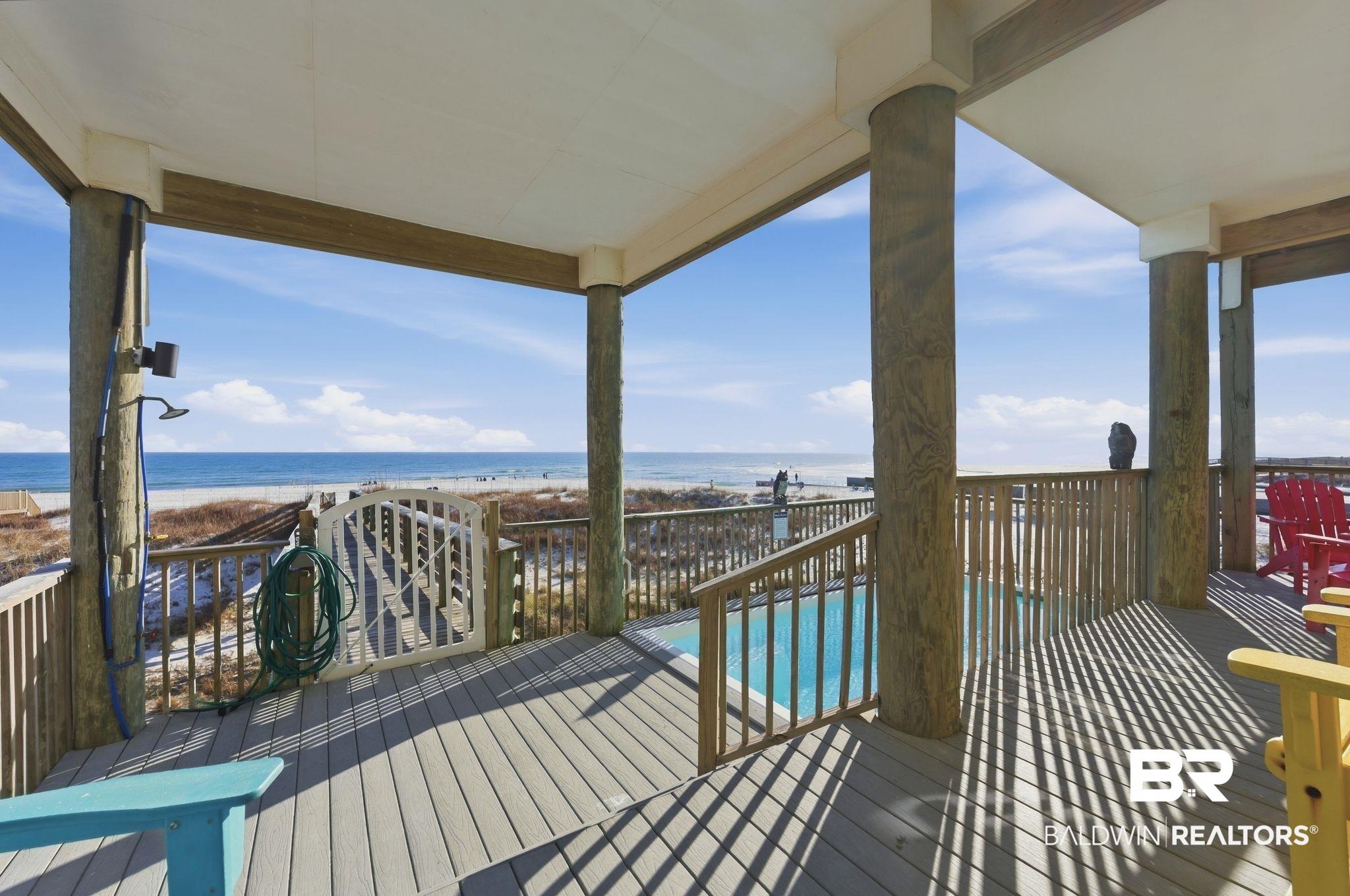 Image 4: Wooden deck featuring view of water and beach