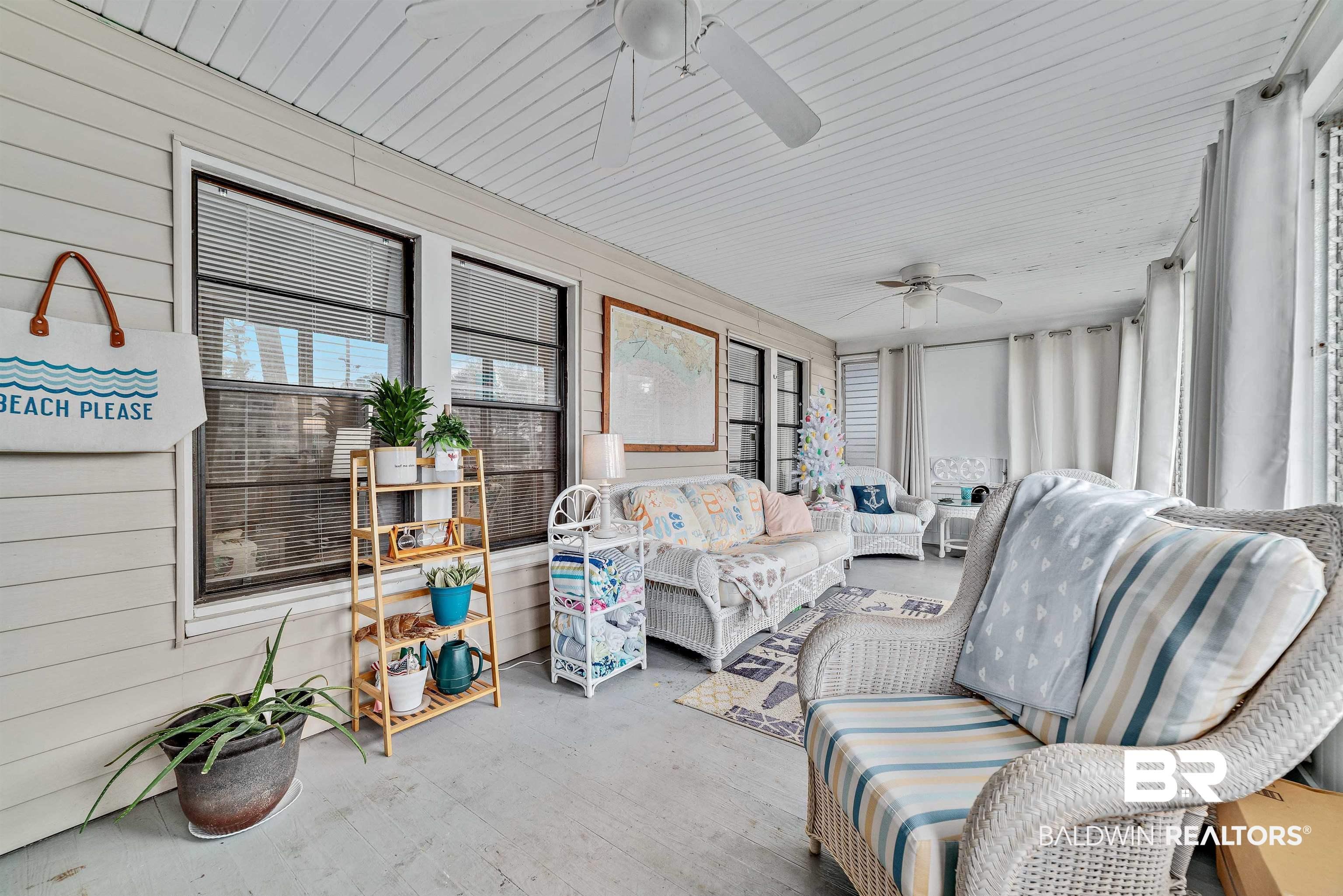 Image 2: Sunroom with wooden walls and wood finished floors