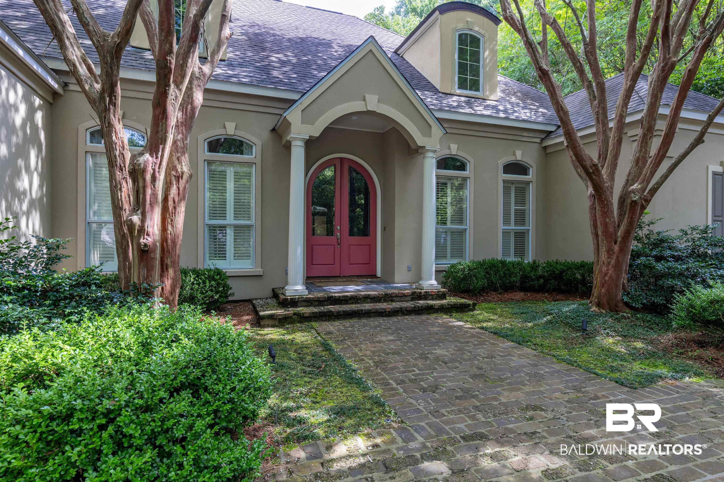 Image 2: Doorway to property with stucco siding and french doors