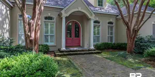 Image 2: Doorway to property with stucco siding and french doors
