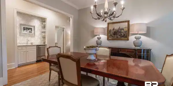 Image 3: Dining room with suspended lighting, crown molding, and light wood-style flooring