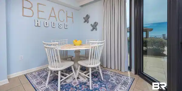 Image 3: Dining area featuring tile flooring, light blue walls, and a large sliding glass door with a patio beyond