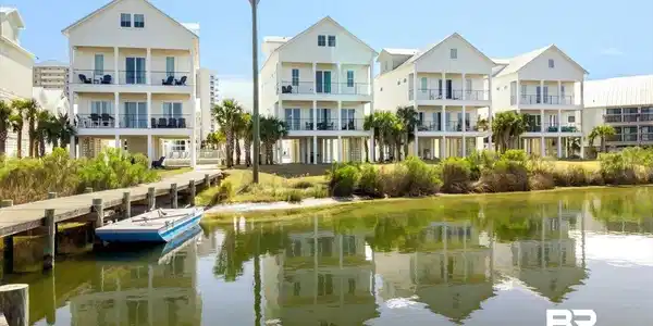 Image 3: Waterfront property featuring multiple two-story balconies and private dock access