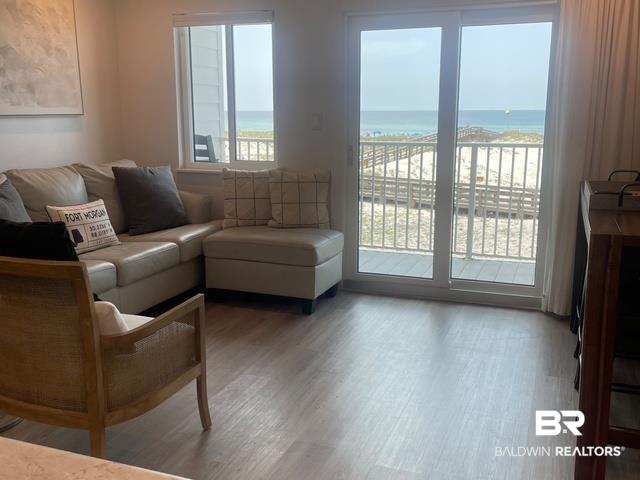 Image 1: Sliding glass doors opening to an outdoor area with beach access