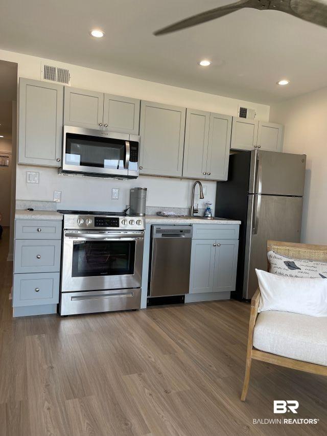 Image 4: Kitchen featuring light-toned cabinetry, stainless steel appliances, and a light-colored countertop