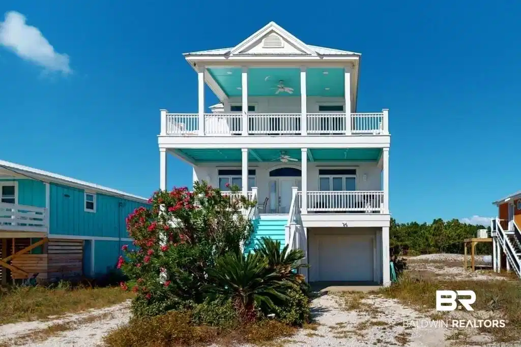 Image 1: Coastal inspired home featuring covered porch, stairway, a ceiling fan, driveway, and an attached garage