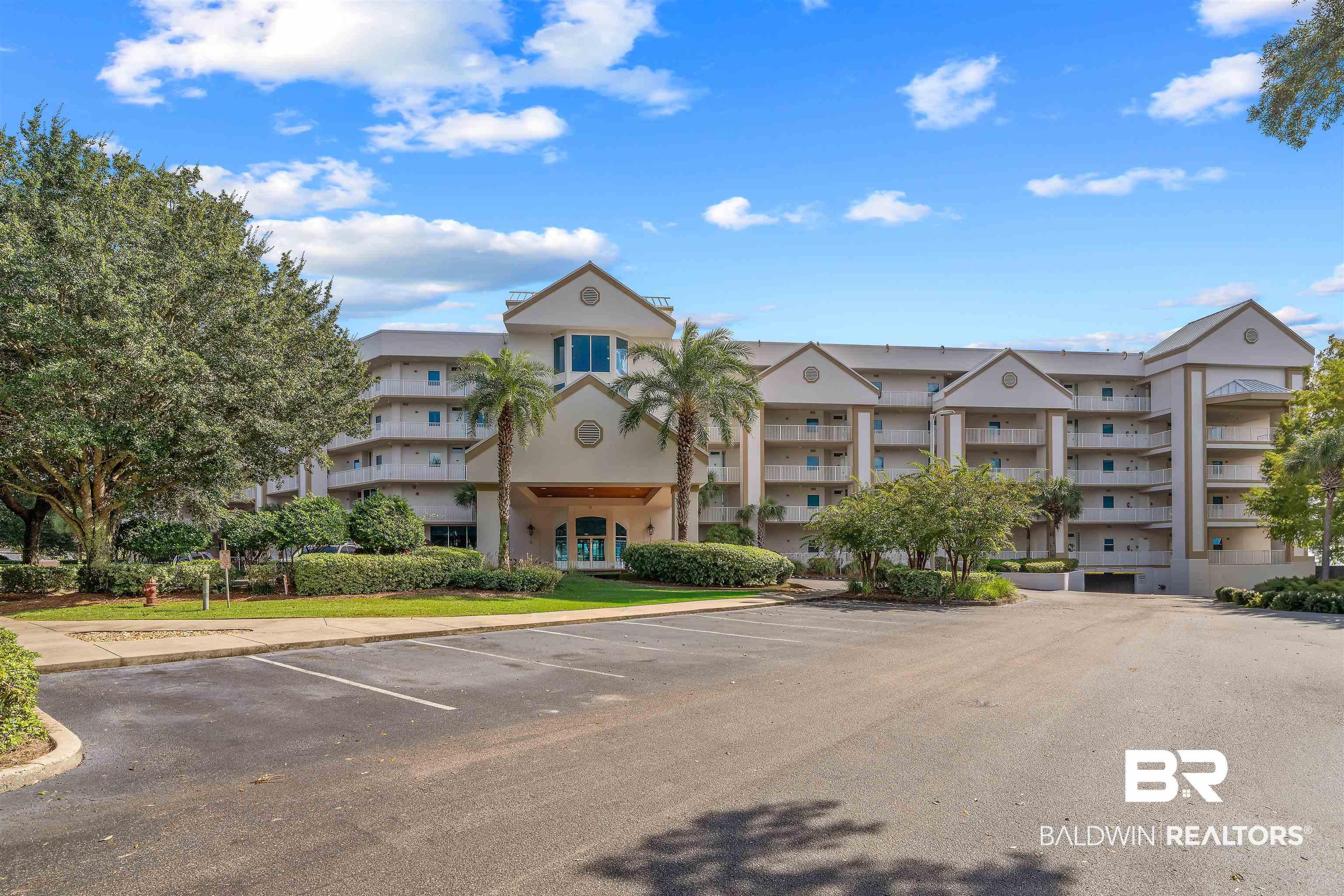 Image 2: View of apartment building / complex featuring uncovered parking