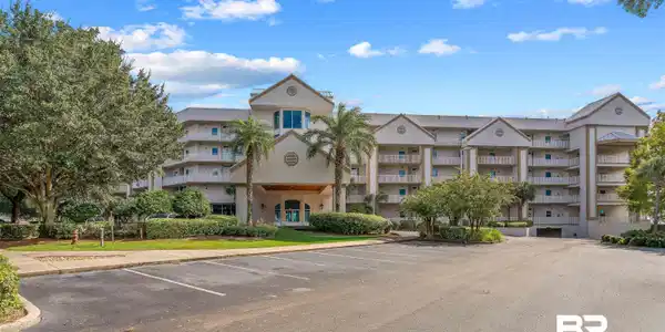 Image 2: View of apartment building / complex featuring uncovered parking