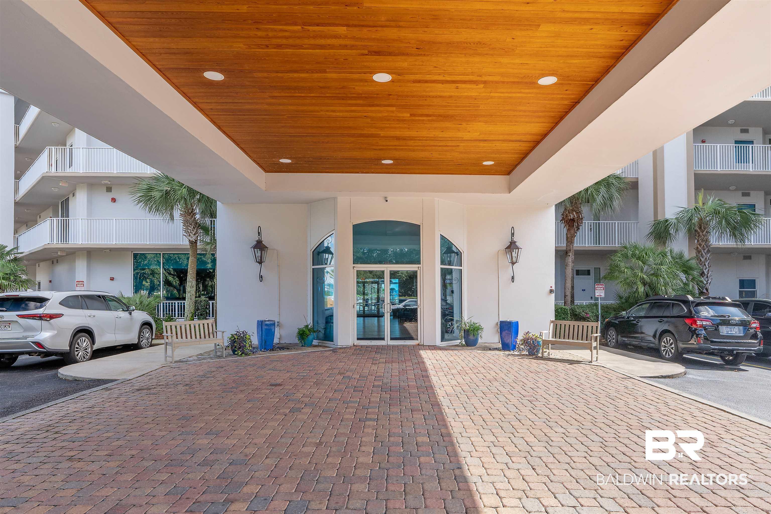 Image 4: View of exterior entry featuring stucco siding and french doors