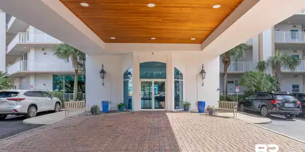Image 4: View of exterior entry featuring stucco siding and french doors