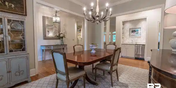 Image 4: Dining room featuring light wood-style flooring, ornamental molding, and suspended lighting