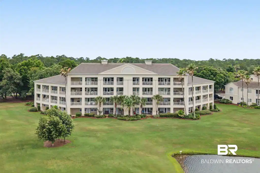 Image 1: Multi-story building featuring multiple private balconies, a stucco exterior, and a gabled roofline