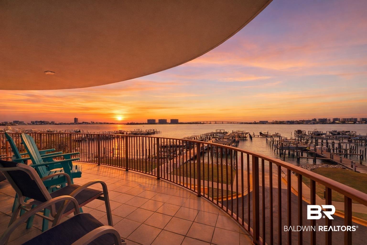 Image 3: Balcony featuring a water view