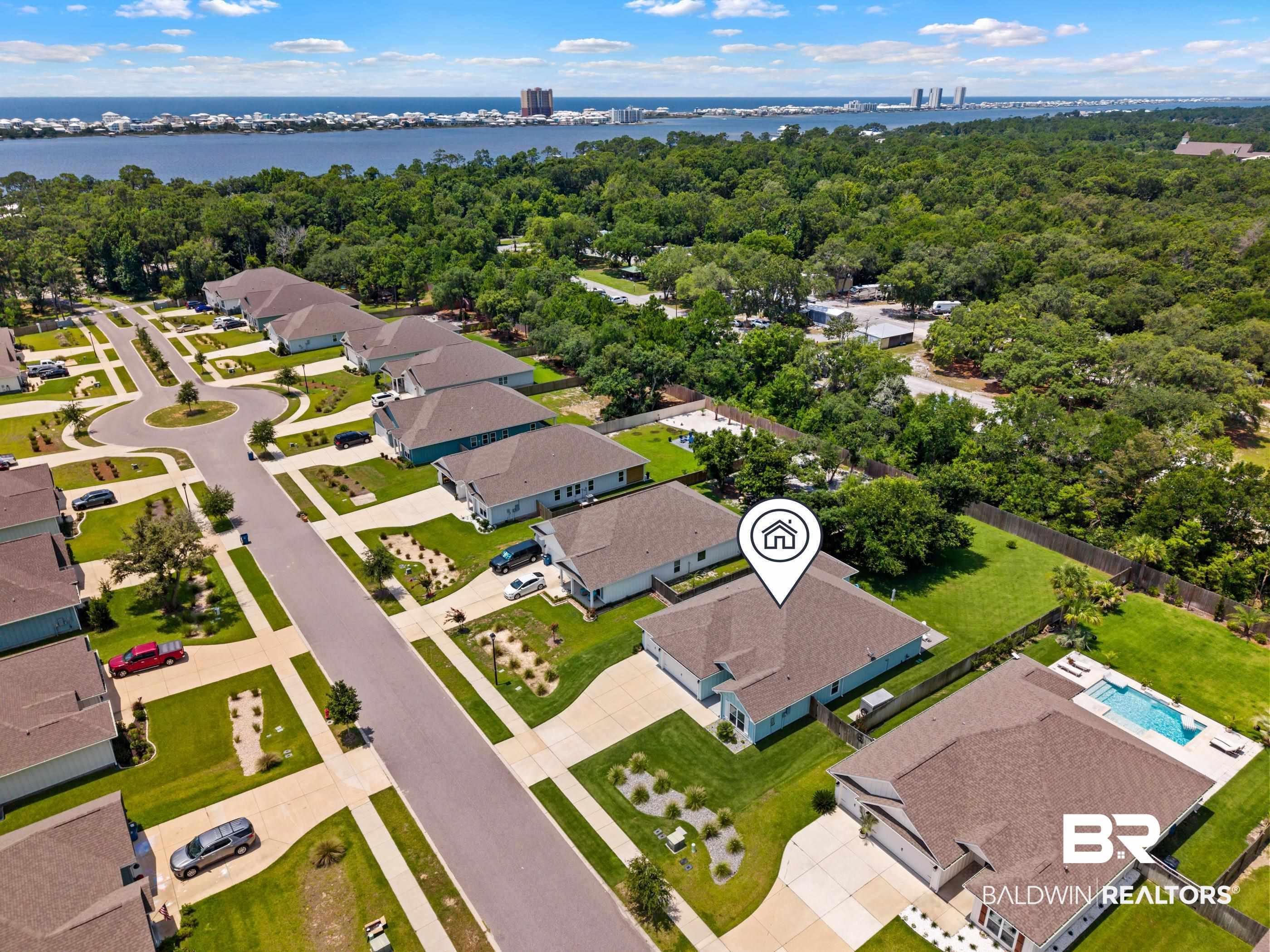 Image 2: Aerial depiction of a neighborhood featuring residential properties with manicured lawns