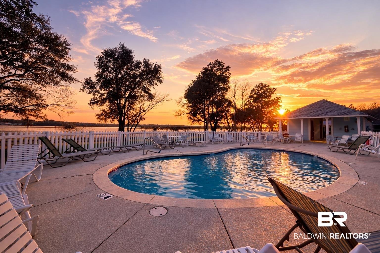 Image 2: Community pool with a patio area
