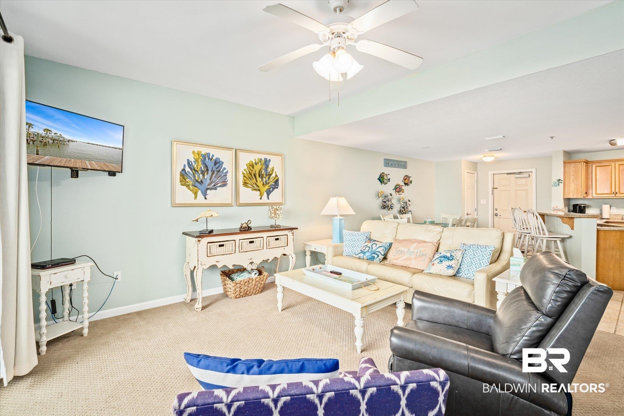 Image 3: Living area featuring carpet flooring and a ceiling fan