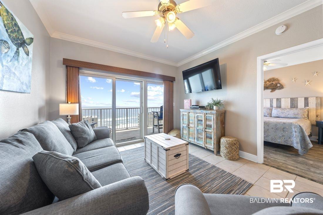 Image 3: Living area with ornamental molding, ceiling fan, and light tile patterned floors