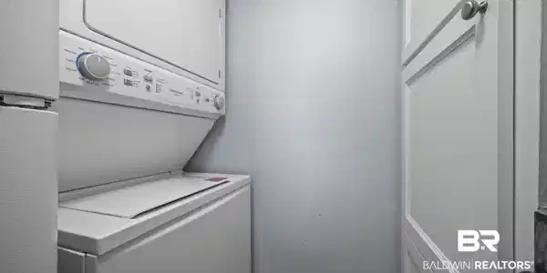 Image 4: Laundry area featuring stacked washer and dryer