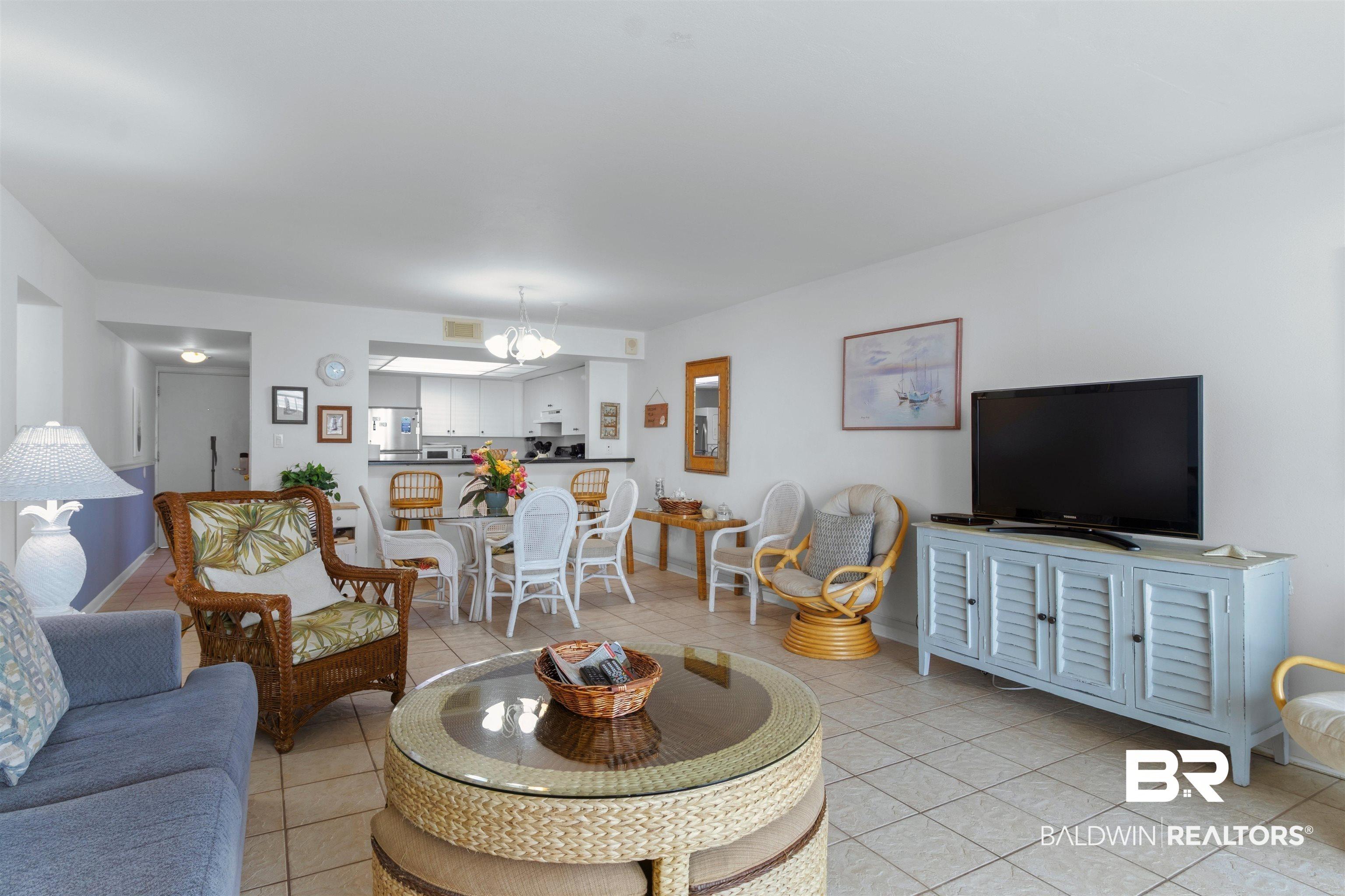 Image 4: Open concept living area featuring tile flooring throughout