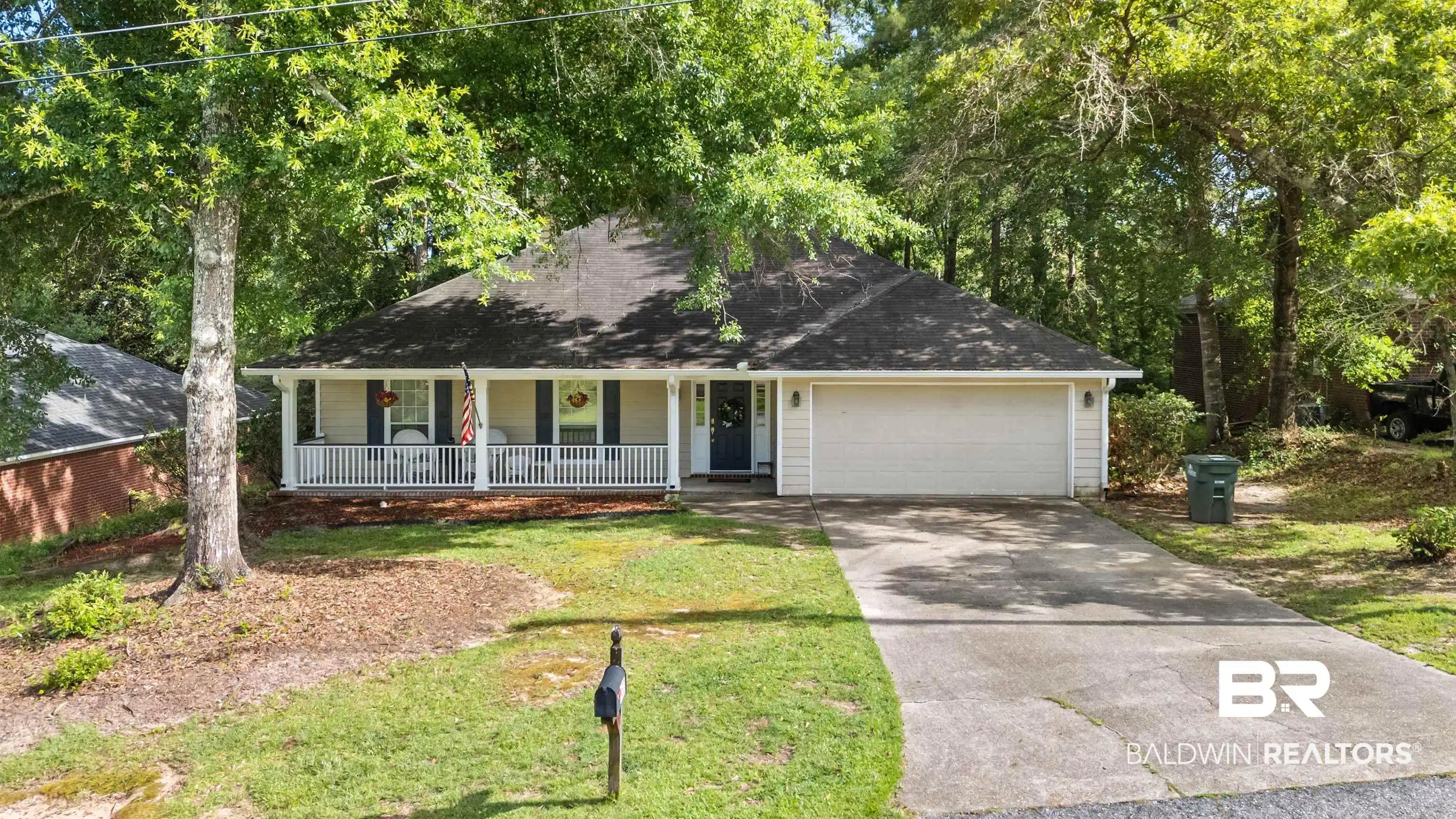 Image 1: Welcome home to 153 Lakeview Loop, where mature trees, timeless appeal, and a sought-after Lake Forest location create an inviting first impression.