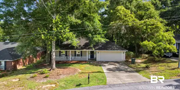 Image 2: Nestled beneath a canopy of established trees, this property offers a peaceful setting while remaining close to everything Daphne has to offer.
