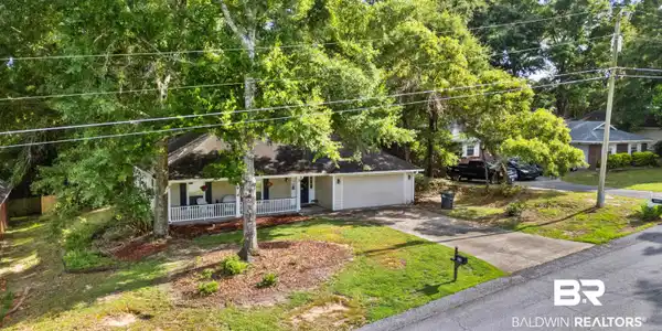Image 4: Thoughtfully positioned among mature landscaping, this home blends privacy, comfort, and neighborhood charm.
