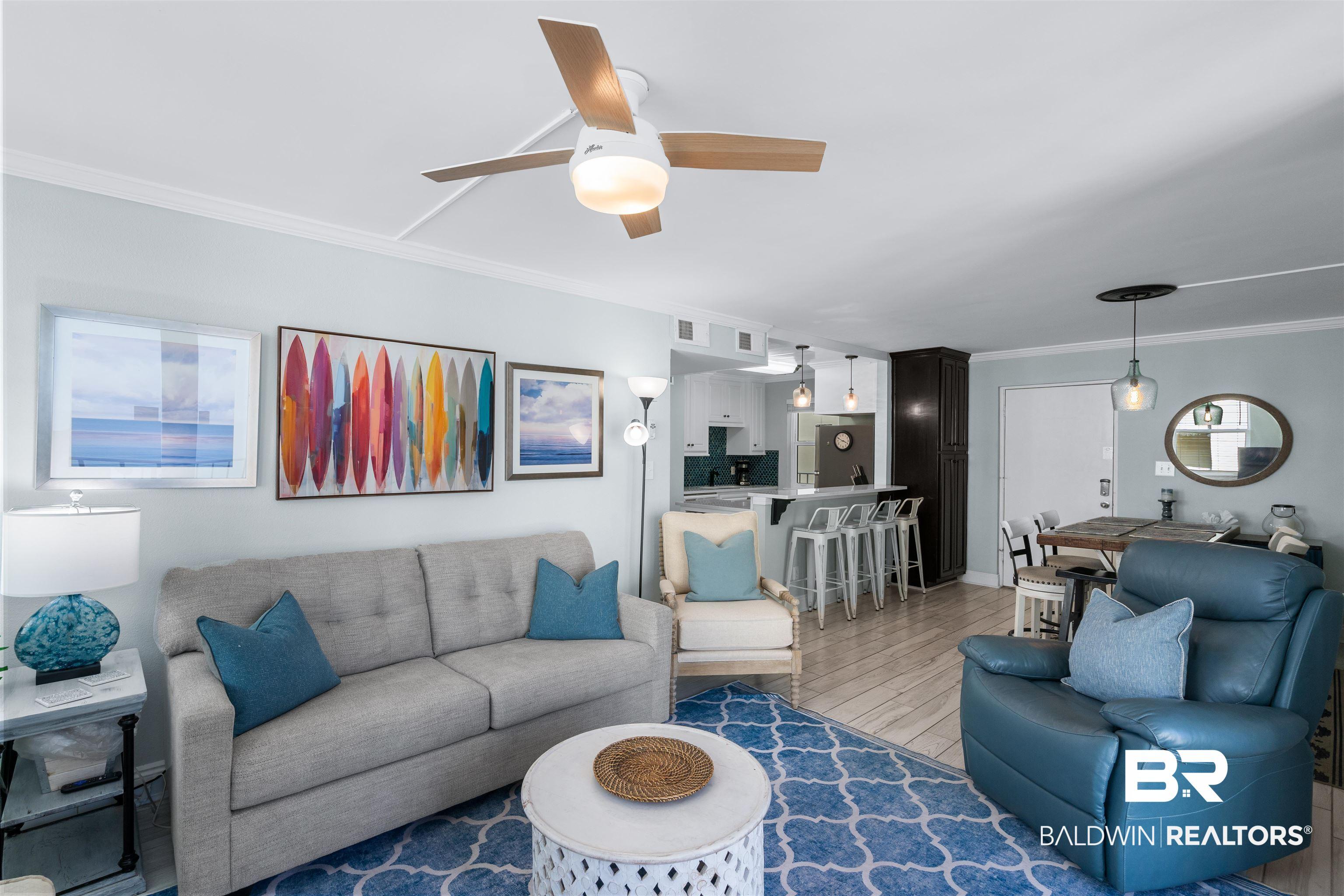 Image 3: Living room with crown molding, light wood-style flooring, and ceiling fan