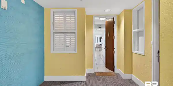 Image 2: Corridor with baseboards and a textured wall