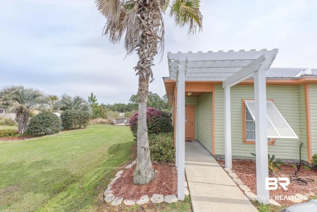 Image 2: Exterior space featuring a yard, a metal roof, and a pergola