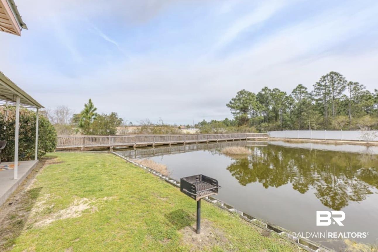 Image 3: Dock with a water view and a yard