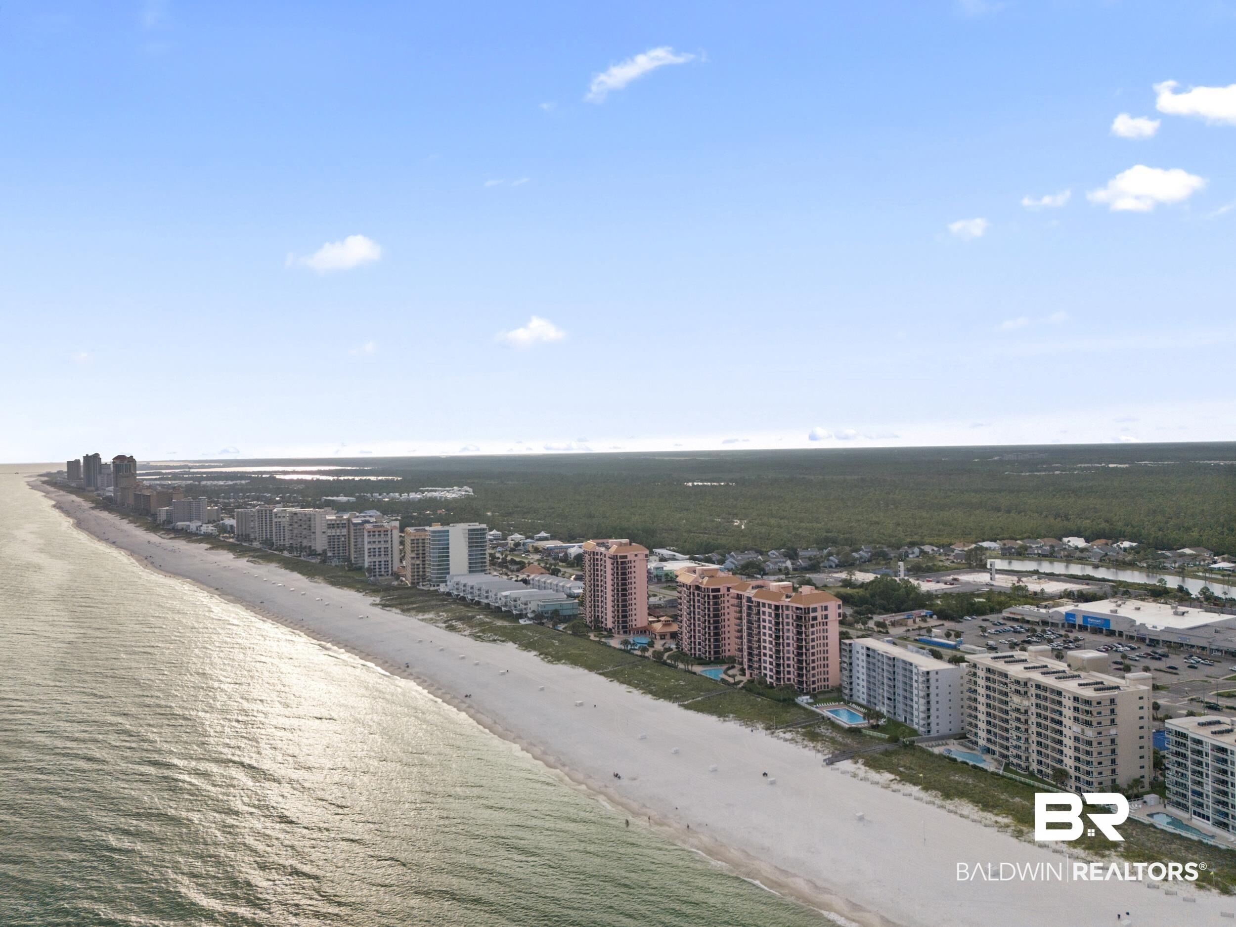 Image 3: Birds eye view of property with a water view and a beach view