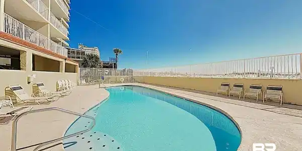 Image 3: Community pool featuring a patio area