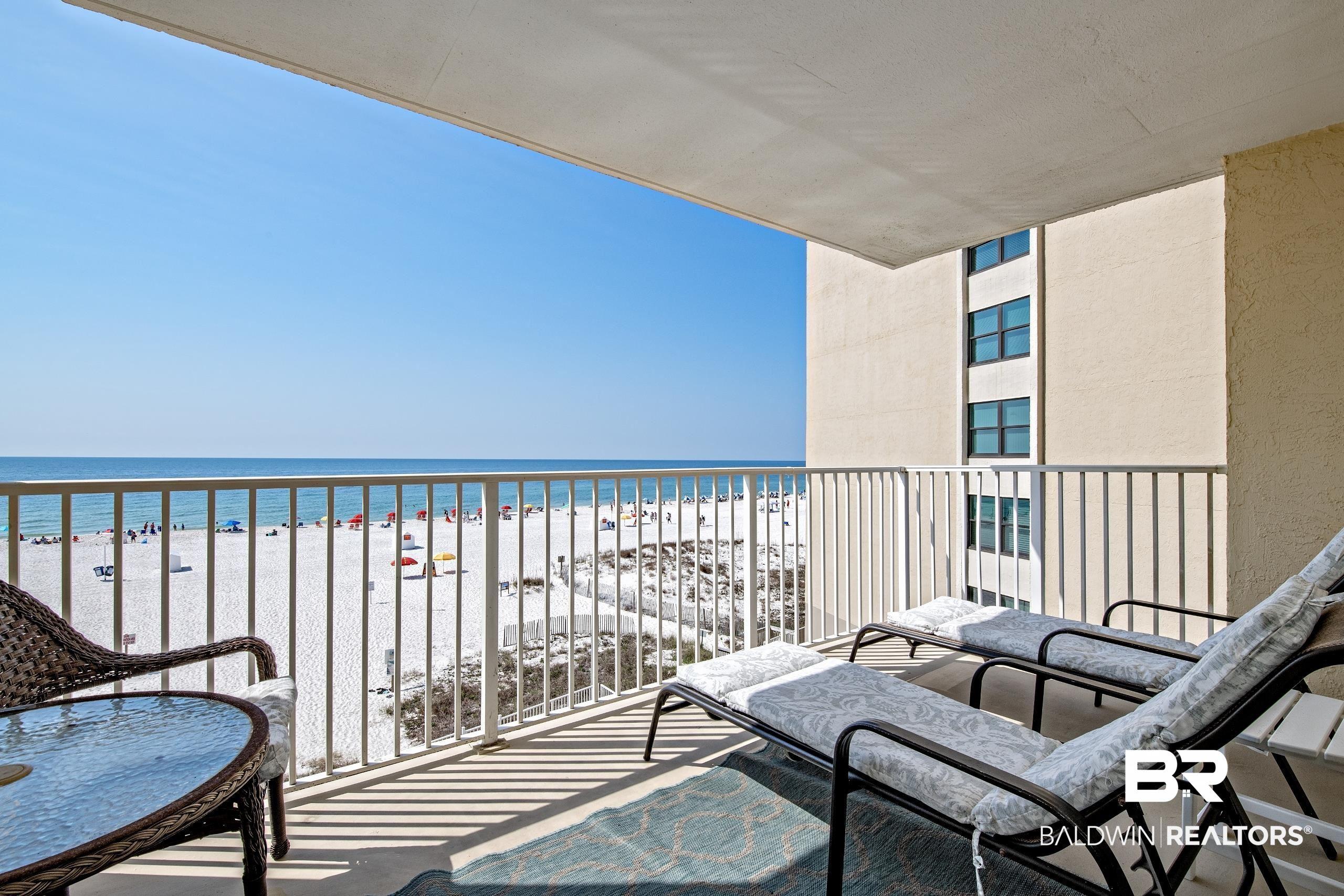 Image 4: Balcony featuring view of water and beach