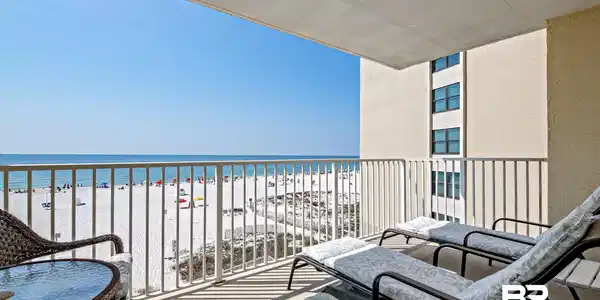 Image 4: Balcony featuring view of water and beach